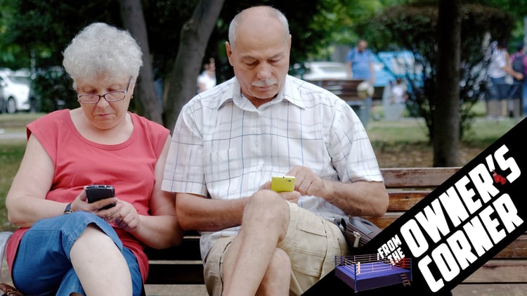 Boomers on Cell Phones Sitting on Bench