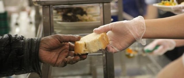 handing bread to the needy