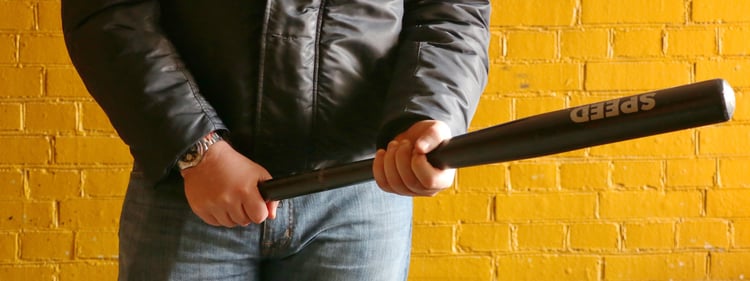 man in leather jacket holding a baseball bat